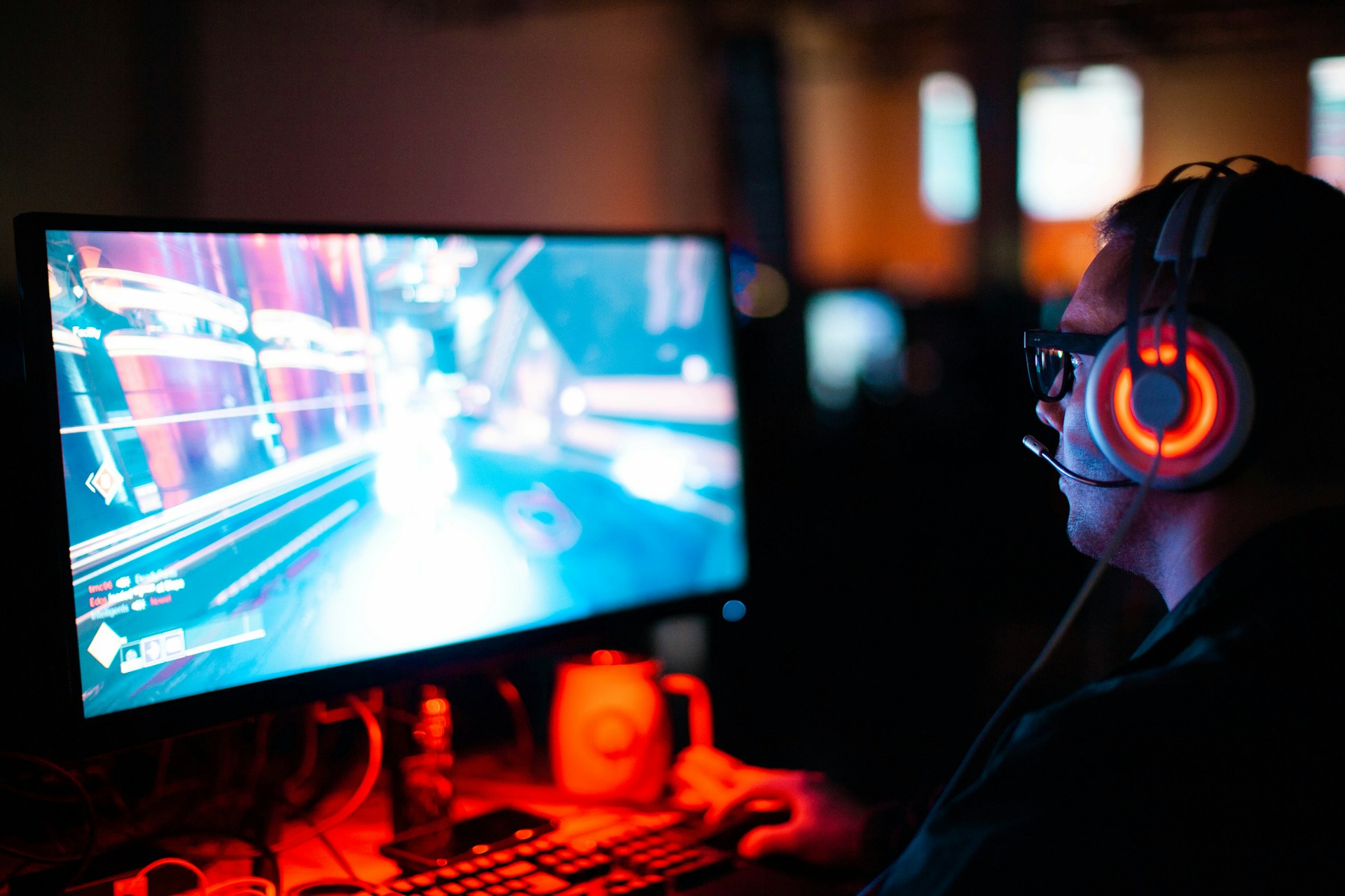 a person using a computer playing an FPS game